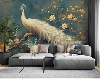 May include: A large, ornate mural featuring a white peacock perched on a branch with trailing feathers. The background is a deep teal with floral accents. A gray sectional sofa, marble table, and potted plant complete the scene.