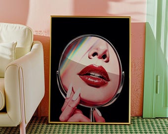 May include: A framed artwork featuring a close-up of a face reflected in a round mirror. The image highlights the red lips and nose, with a black background. The hand holding the mirror has long, white nails. The artwork is in a gold frame.