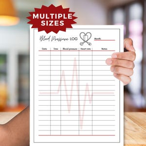 以下が含まれることがあります： 赤い心拍数グラフと「Blood Pressure LOG」の文字が入った白い血圧記録シート。シートは人が持っています。シートの上部には「MULTIPLE SIZES」と書かれた赤いスターバーストがあります。