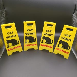 May include: A set of three ceramic mugs with a speckled, matte finish. The mugs are in shades of cream, light gray, and dark gray. Each mug has a simple, minimalist design, perfect for coffee or tea.