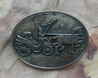 Sterling silver pin brooch featuring horse and carriage and a couple