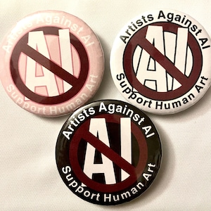 May include: Three round buttons with the text "Artists Against AI" and "Support Human Art". The buttons are in pink, white, and black, each with a red prohibition symbol over the letters "AI".