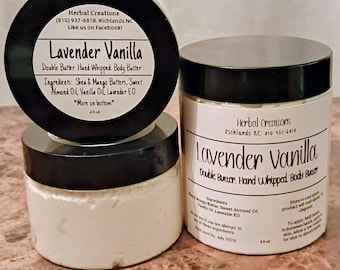 May include: Three jars of Lavender Vanilla double butter. The jars have black lids and white labels with text. The labels list ingredients like shea butter and vanilla oil. The jars are stacked on a brown surface.