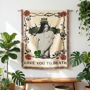 May include: A beige tapestry with a central image of a person within a green cross, surrounded by roses and thorns. The text "LOVE YOU TO DEATH" is at the bottom. A green heart graphic is on the lower left.