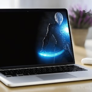 May include: A laptop computer with a dark background and a blue glowing sword on the screen. The sword is held by a person with white hair and a black outfit.