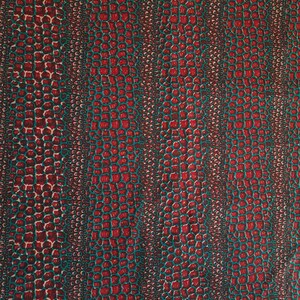 May include: Red and teal fabric with a crocodile skin pattern.