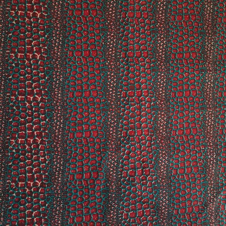 May include: Red and teal fabric with a crocodile skin pattern.