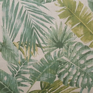 May include: A fabric with a green and white tropical leaf pattern. The leaves are stylized and have a vintage look.
