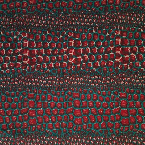 May include: Red and teal fabric with a repeating pattern of small, irregular shapes. The pattern resembles a crocodile skin.