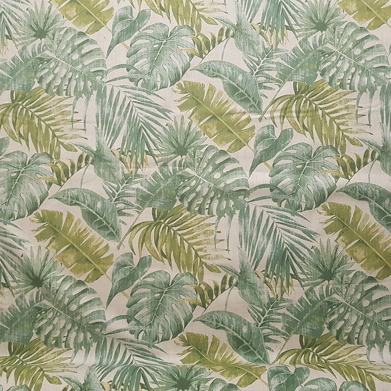 May include: A seamless fabric pattern featuring a repeating design of green tropical leaves on a white background.