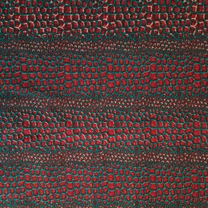 May include: Red and teal fabric with a repeating pattern of small, rounded shapes. The pattern resembles a crocodile skin.