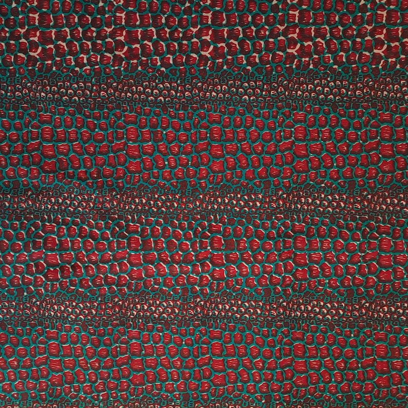 May include: Red and teal fabric with a repeating pattern of small, rounded shapes. The pattern resembles a crocodile skin.