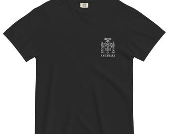 May include: Black t-shirt featuring a white graphic of a stylised figure and the word "ANNUNAKI" underneath.