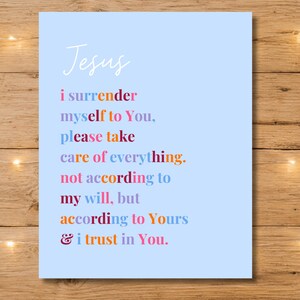 May include: A light blue print with the word "Jesus" in cursive script. The text below is in various colors and reads "i surrender myself to You, please take care of everything. not according to my will, but according to Yours & i trust in You."