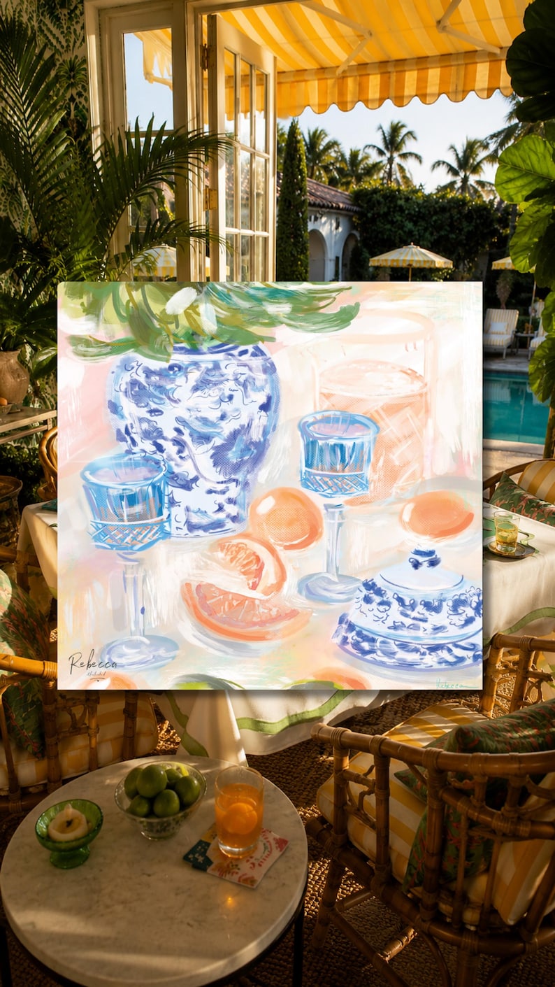 May include: A colorful painting depicting a blue and white patterned ceramic vase, a matching lidded jar, two blue glass goblets, and sliced citrus fruits on a table. The artwork features visible brushstrokes and the signature Rebecca in the corner.
