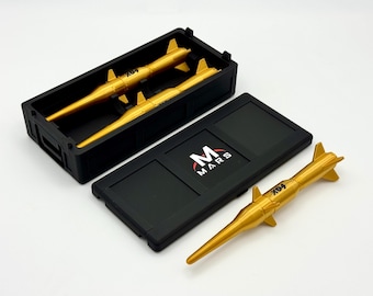 May include: A black rectangular storage case with a lid featuring the text MARS and a red arc logo. Inside the case are two gold-colored missile replicas, with a third identical gold missile placed outside the case. Each missile is marked X04.