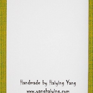 May include: White card with black text that reads "Handmade by Haiying Yang" and "www.yanghaiying.com".