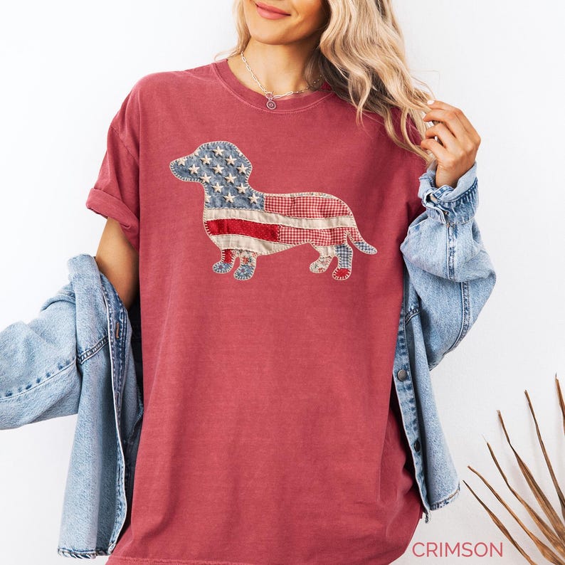 Crimson Comfort Colors patriotic dachshund patchwork t-shirt for women, featuring a large quilted wiener dog graphic with embroidered white stars, denim blue, red gingham, cream floral, and striped fabric — 4th of July dachshund mom gift, American flag wiener dog tee, cute dog mom patriotic shirt, patchwork dachshund Comfort Colors tee, dachshund lover gift idea.