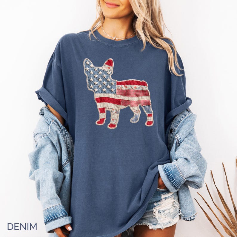 Denim Comfort Colors patriotic French Bulldog patchwork t-shirt for women, featuring a large quilted Frenchie silhouette with embroidered white stars, denim blue, red gingham, cream floral, and striped fabric — 4th of July Frenchie mom gift, American flag French Bulldog tee, dog mom patriotic shirt, patchwork Frenchie Comfort Colors tee, French Bulldog lover gift idea.