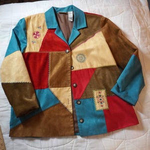 May include: A patchwork jacket in a variety of colors including teal, red, tan, and brown. The jacket has a collared neckline, long sleeves, and decorative stitching. It features three buttons down the front and embroidered details.