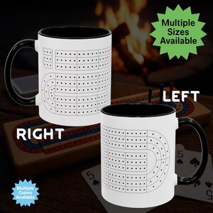 May include: White ceramic mug with a black interior and handle, featuring a cribbage board design. The mug has a classic shape and is suitable for hot or cold drinks. The text "RIGHT" and "LEFT" are visible on the mug.