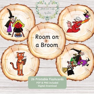 May include: Five circular wood slice graphics featuring Room on a Broom illustrations. One shows a witch with a cauldron, one a dragon, one a cat, and one a witch on a broom with animals. The centre slice displays the text Room on a Broom.