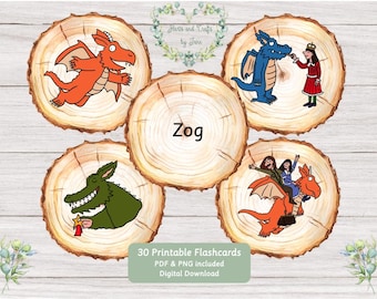 May include: Five circular wood slice designs featuring Zog characters. One shows an orange dragon, one a blue dragon with a person, one a green dragon holding a star, one a person riding an orange dragon, and one with the text Zog.