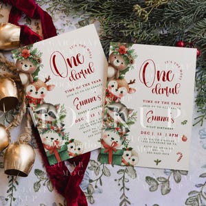 May include: Two rectangular birthday invitation cards featuring watercolor illustrations of a bear, deer, raccoon, and owl with holiday greenery. The text reads: It's the most wonderful time of the year, join us to celebrate Emma's first birthday.