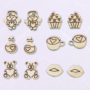 May include: Set of 10 laser cut wooden Valentine's Day themed shapes, including angels, cupcakes, potion bottles, coffee cups, lips, and teddy bears. Each shape features a heart design.