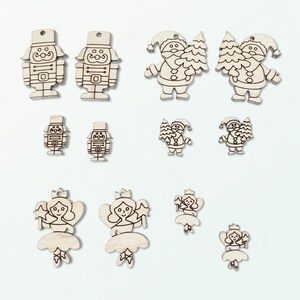 May include: A selection of wooden Christmas decorations. The ornaments feature designs of nutcrackers, Father Christmases with trees, and angels. Each decoration has a small hole for hanging and is made from light-coloured wood with etched details.