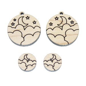 May include: Set of four wooden earrings with a moon and stars design. The earrings are laser cut and have a natural wood finish.