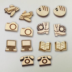 May include: Set of 12 wooden earrings with various designs, including airplanes, cameras, laptops, books, telephones, and boots. The earrings are laser cut and have a natural wood finish.