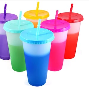 Könnte beinhalten: Sechs wiederverwendbare Kunststoffbecher mit Deckeln und Strohhalmen in verschiedenen Farben: Lila, Grün, Gelb, Pink, Blau und Rot. Die Becher wechseln die Farbe, wenn kalte Flüssigkeiten eingefüllt werden.