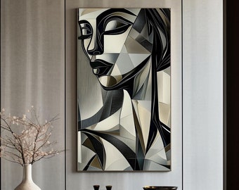 May include: A black and white abstract portrait of a woman's face hangs on a wall in a modern interior. The artwork is framed and is the focal point of the room.
