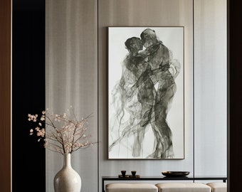 May include: A black and white abstract art print of two figures embracing. The print is framed and hanging on a wall in a modern living room with a white rug, a wooden coffee table, and a vase of white flowers.
