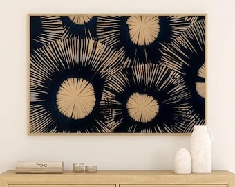 May include: A light wood dresser with six drawers and gold-toned hardware. The dresser is in front of a white wall with a black and white abstract art print above it.