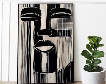 May include: Black and white abstract art print of a face with closed eyes and a bold lip. The print is framed in a black frame and is hanging on a white wall.