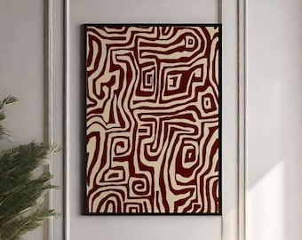 May include: A white couch with brown throw pillows and a brown throw blanket in front of a white wall with a framed abstract print featuring red and cream lines.