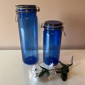 2 vintage glass, cobalt blue narrow, paneled kitchen canisters, jars with latch closures / vintage kitchen counter storage, has issues
