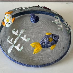 Round domed, mesh food cover, food saver, picnic pal  decorated with  colorful straw raffia fish / outside food covers / has issue
