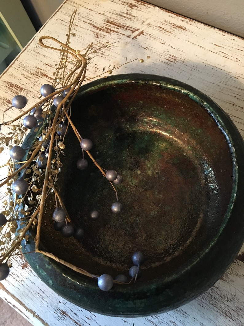 handmade pottery bowl done in deep iridescent coppery blues and greens Small sculpted in 1988 by Tom R Johnson shallow pottery bowl