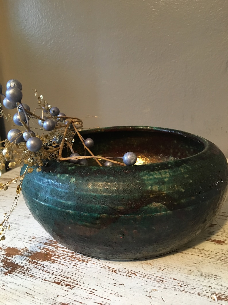 handmade pottery bowl done in deep iridescent coppery blues and greens Small sculpted in 1988 by Tom R Johnson shallow pottery bowl