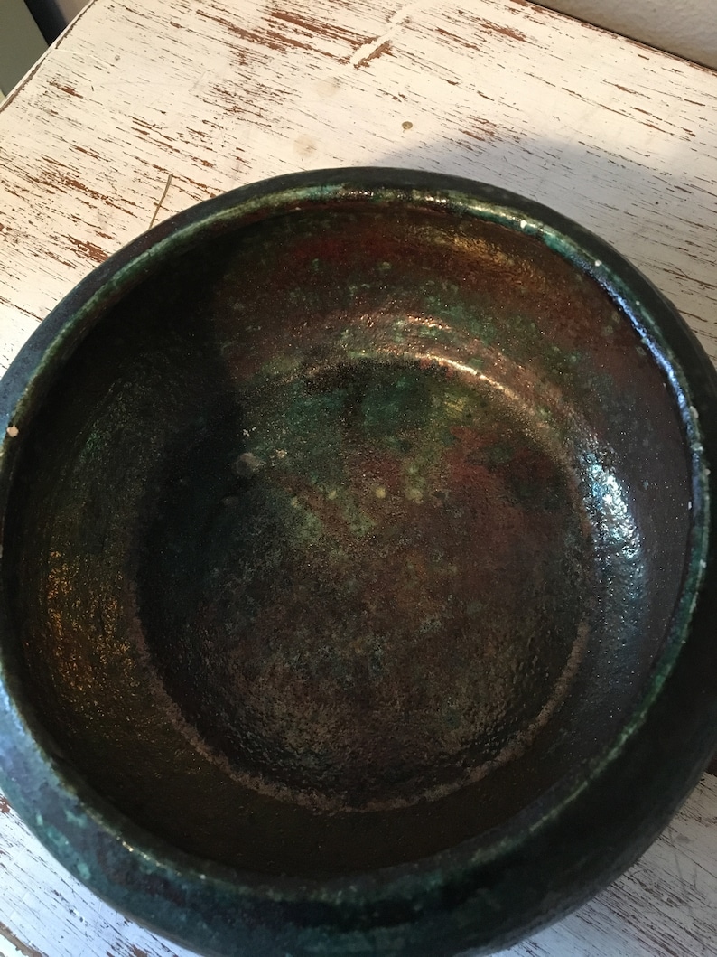 handmade pottery bowl done in deep iridescent coppery blues and greens Small sculpted in 1988 by Tom R Johnson shallow pottery bowl