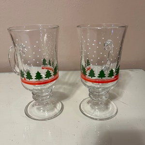 Premium AI Image  A pair of hot toddy glasses gently resting on a wooden  table