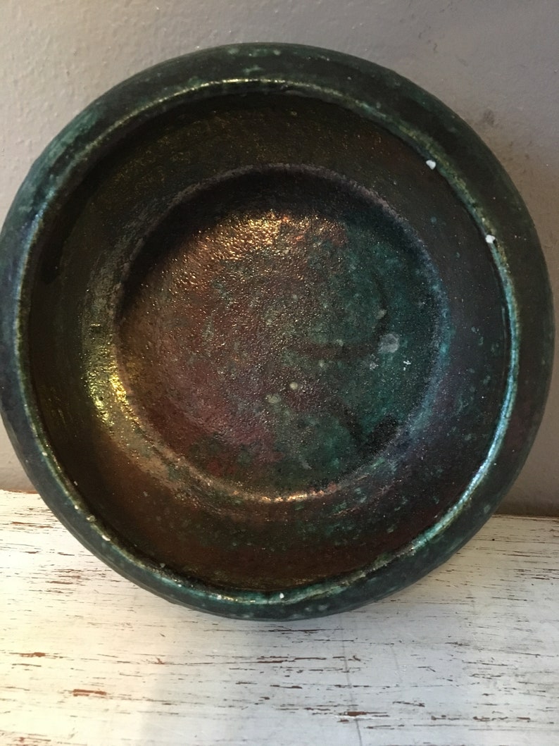 handmade pottery bowl done in deep iridescent coppery blues and greens Small sculpted in 1988 by Tom R Johnson shallow pottery bowl