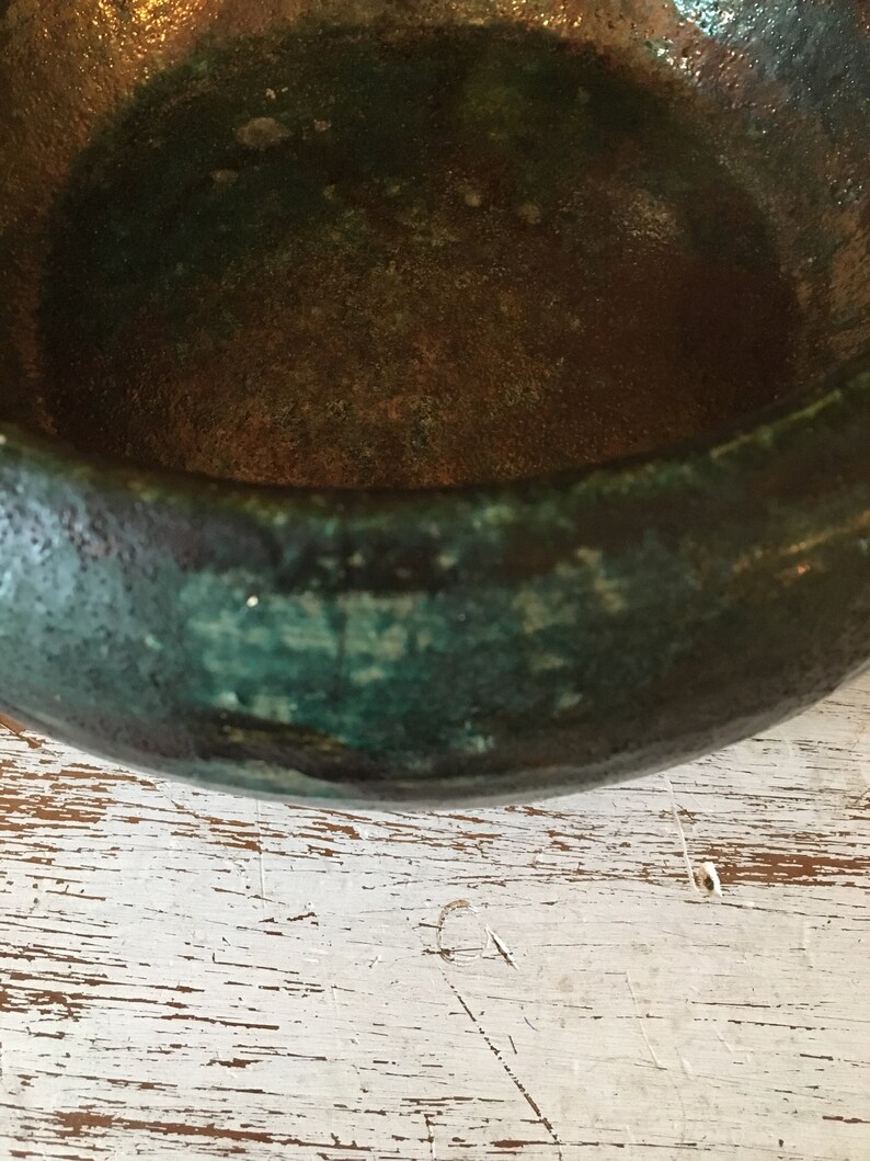 handmade pottery bowl done in deep iridescent coppery blues and greens Small sculpted in 1988 by Tom R Johnson shallow pottery bowl