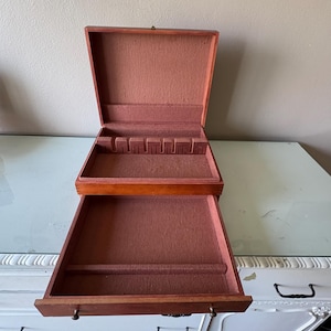 May include: A set of three ceramic mugs with a speckled, matte finish. The mugs are in shades of cream, light gray, and dark gray. Each mug has a simple, minimalist design, perfect for coffee or tea.