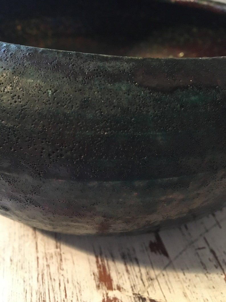 handmade pottery bowl done in deep iridescent coppery blues and greens Small sculpted in 1988 by Tom R Johnson shallow pottery bowl