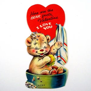 May include: Vintage Valentine's Day card featuring a cartoon bear in a bathtub. The bear is washing with a sponge, with a red heart above it that says "Here are the BEAR facts, Valentine, I LOVE YOU". A towel hangs nearby.