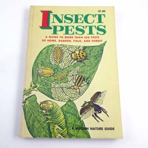 May include: A vintage book titled "Insect Pests: A Guide to More Than 350 Pests of Home, Garden, Field, and Forest." The cover features a colorful illustration of various insects on a green leaf.